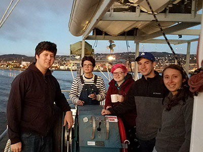Students on a ship posing for the camera.